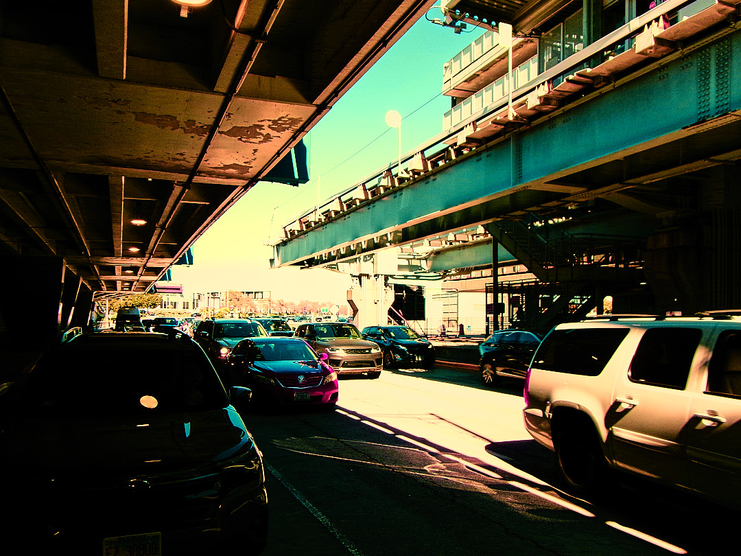Cars queued along the terminal road under the elevated roadway